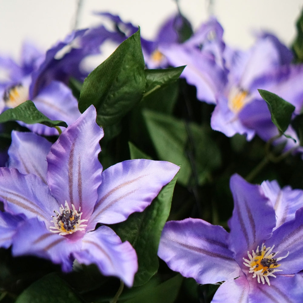Lavender Faux Clematis Arrangement in Natural Hyacinth Hanging Basket