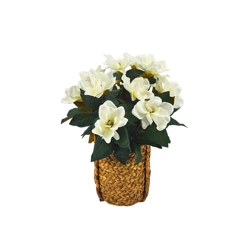 Artificial flower arrangement in a woven basket on a white background