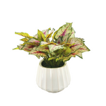 Artificial green plant with pink accents in a white pot on a white background