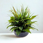 Artificial Mixed Greenery in Glossy Black Dimpled Ceramic Bowl placed in front of a white backdrop, by House of Silk Flowers.