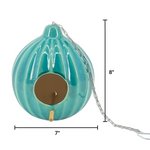 Turquoise bird feeder with chain and measurements on a white background