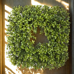 Artificial green wreath on a wooden door