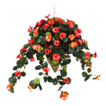 Artificial hanging basket with red and orange flowers on a white background