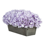 Violet hydrangeas in rectangular grey ledge on white background