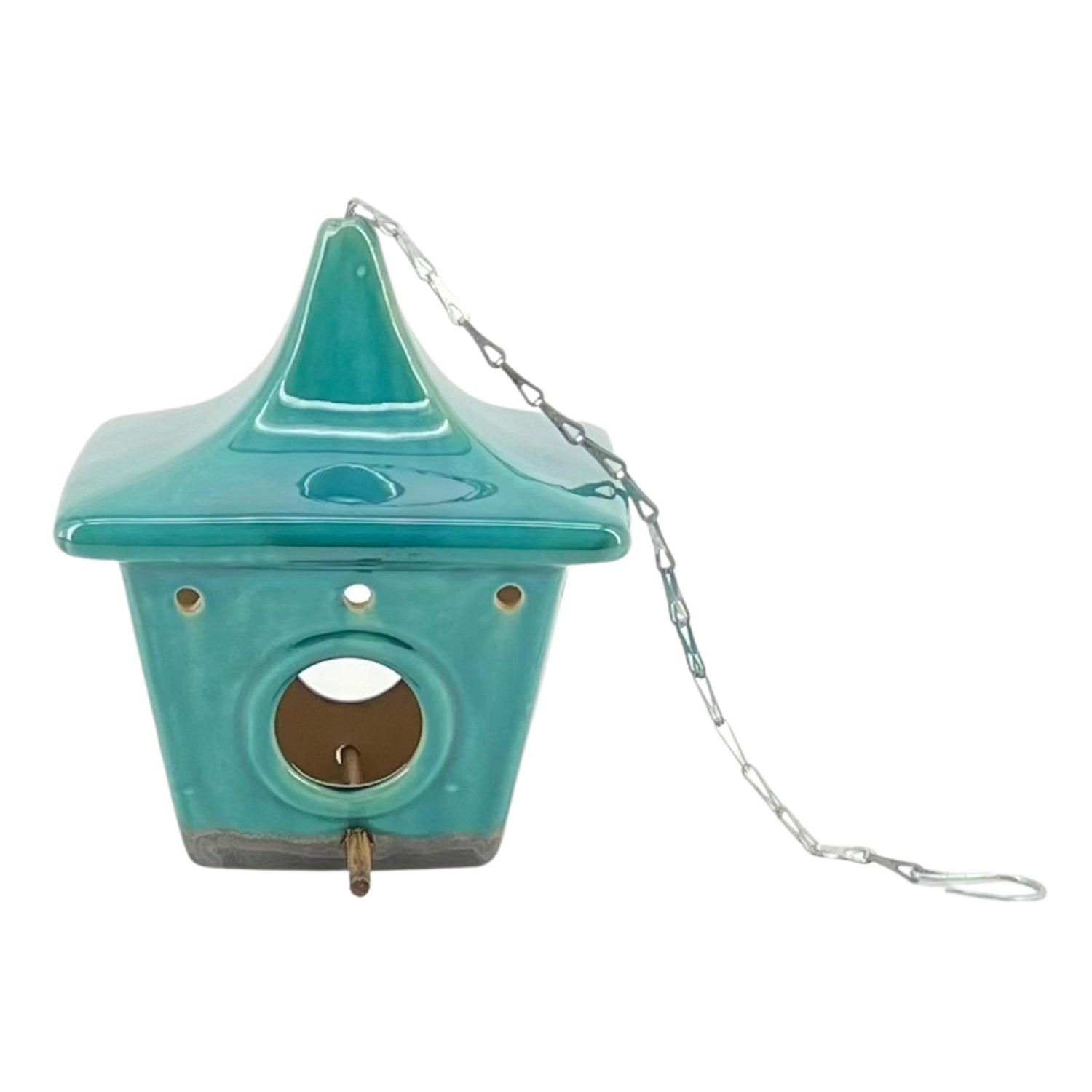 A blue ceramic square pagoda-shaped birdhouse with a metal chain and hook for hanging.