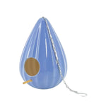 Periwinkle ceramic teardrop-shaped birdhouse with a ruffled design, featuring two large openings, a metal chain for hanging, and a gold-colored interior.